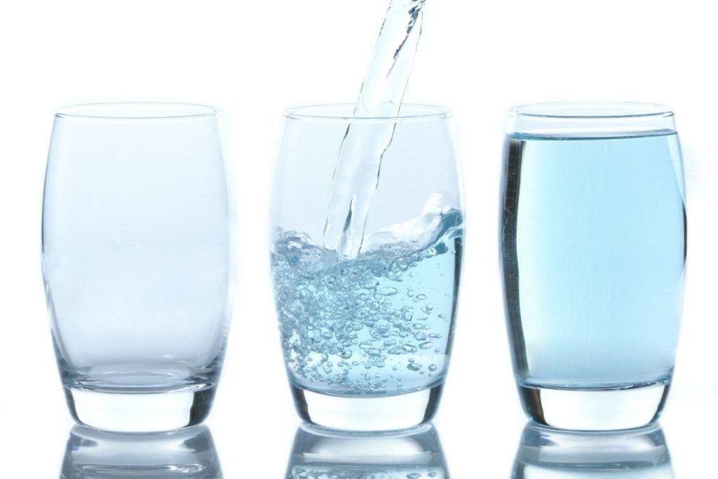 three blue glasses with carbonated water and still water
