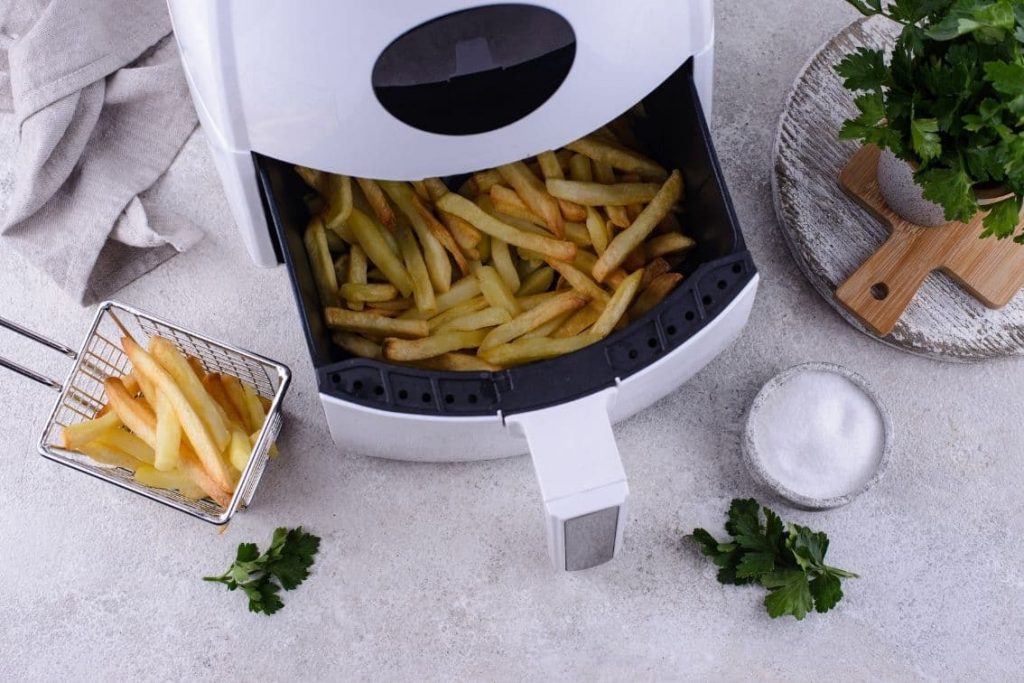 white air fryer with french fries inside